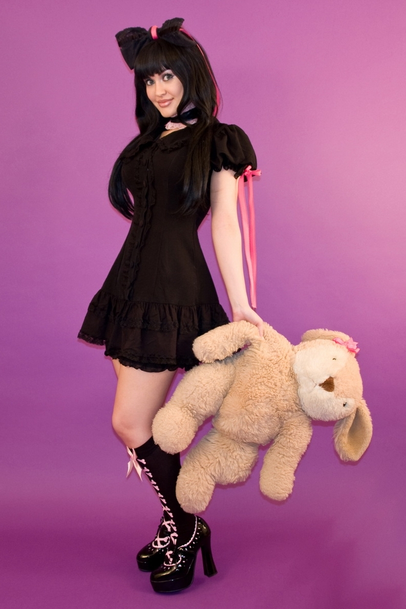 Brunette Gothic Girl with Bare Legs wearing Black Short Dress